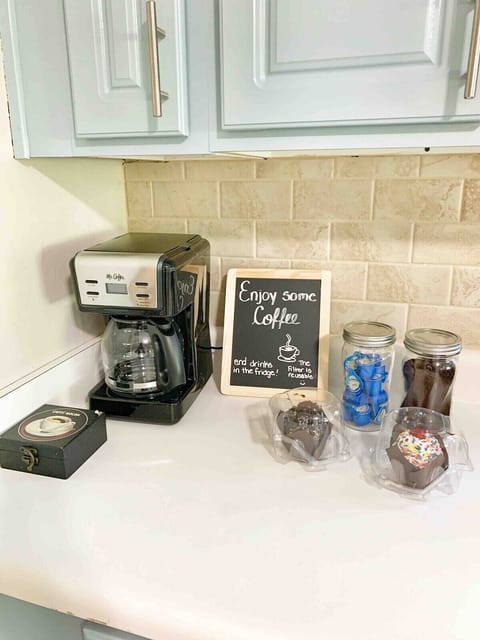 Dedicated coffee bar stocked with mugs, Keurig, and essentials for your daily brew.