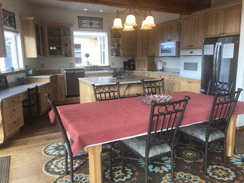 Fully stocked kitchen with large dining room table