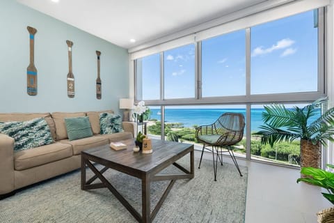 Sink into the plush sofa and gaze out at breathtaking ocean views framed by floor-to-ceiling windows. Your coastal retreat awaits with coastal-themed decor and modern comforts.
