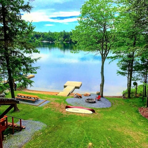 Enjoy the stunning view from the upper cottage`s desk, featuring a sunbathed dock and the shallow waterfront, perfect for peaceful mornings or reflective evenings