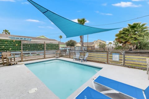 Cool off in your private pool under the shade sail, with comfortable lounge chairs perfect for sunny afternoons.