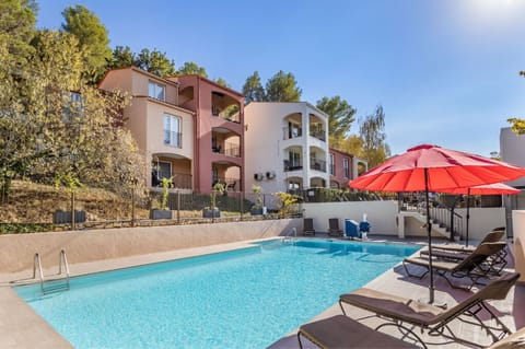 Lounge by the serene poolside, complete with umbrellas and sun loungers for your relaxation.