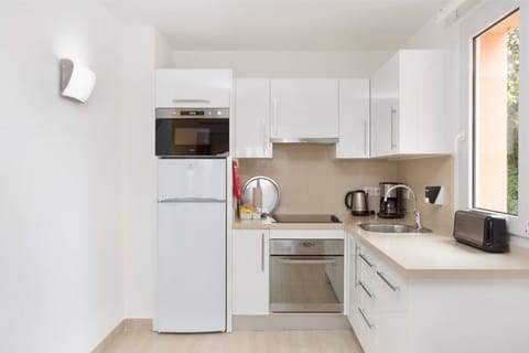 Contemporary kitchen with sleek appliances, ready for culinary exploration.