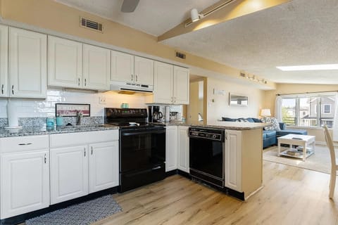 open floor plan with kitchen overlooking the comfortable living room.
