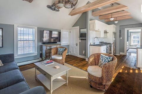Main room with television, bathroom and kitchen and dining area.