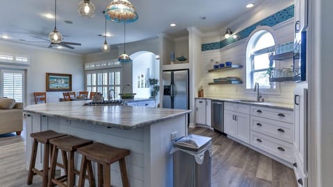 Kitchen with view to front of house and front door foyer.