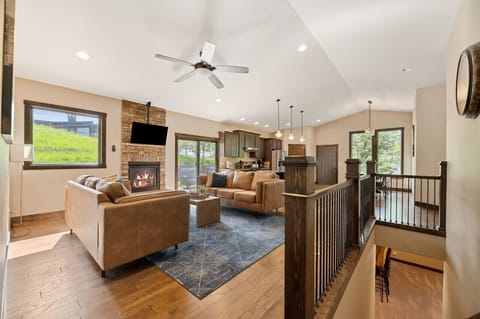 Large open area to entertain! Kitchen, living, dining room with access to the back patios.