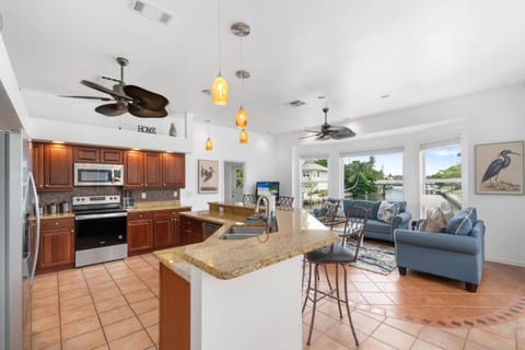 Cook for the crew in a fully-equipped kitchen updated with custom cabinetry, stainless steel appliances, and granite countertops.