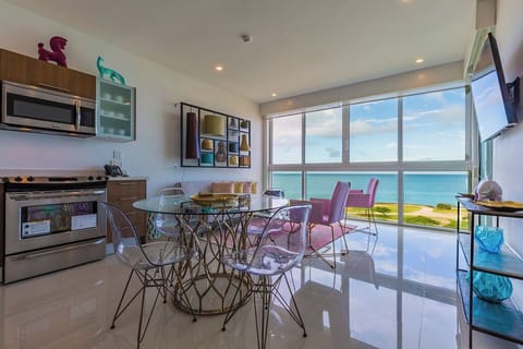 Your stylish oceanfront retreat features floor-to-ceiling windows framing stunning turquoise waters and golden coastline, blending modern design with breathtaking views to create an inspiring beachside escape.