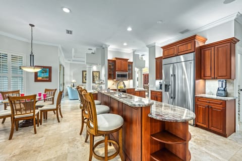 You'll start your mornings perched at the sleek breakfast bar, sipping fresh coffee.