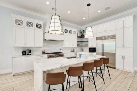 Your dream kitchen awaits with stunning white cabinetry, gleaming countertops, and a spacious island perfect for morning coffee and meal prep.