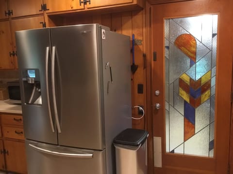 Lg refrigerator with bottom freezer. Glass door to laundry room/outer room