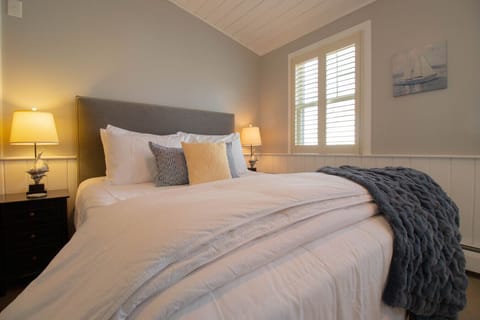 Comfortable queen bed with plush bedding, cozy linens, and plenty of pillows.