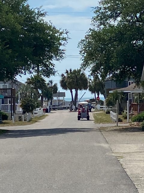 The main road going into the gated beach access. Home is in culdesac to the left