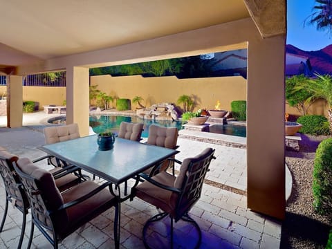 Large covered patio with dining table.
