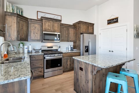 Fully stocked gourmet kitchen featuring top of the line appliances