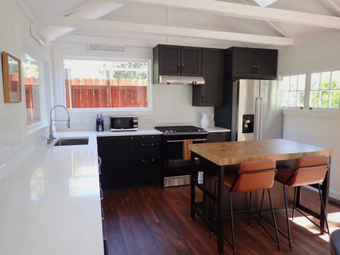 New kitchen with quartz countertops, gas stove and new appliances