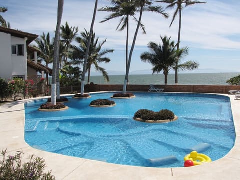 Community shared pool at Villas de Playa Condominium.