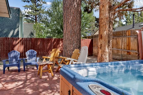 Private outdoor hot tub, surrounded by tall pines, perfect for relaxing under the trees after a day of adventure—enjoy peaceful forest views, fresh air, and a truly rejuvenating stay.