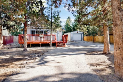 Welcoming cabin entry surrounded by towering pine trees, offering fresh mountain air and a peaceful forest setting—the perfect first impression for your Big Bear Lake getaway.