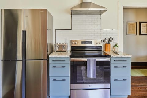 The kitchen is located at one end of the hall. This updated, spacious kitchen is an easy place to cook or hang out.