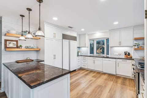 Your fully equipped chef's kitchen features granite countertops, stainless steel appliances, and a spacious island perfect for culinary adventures.