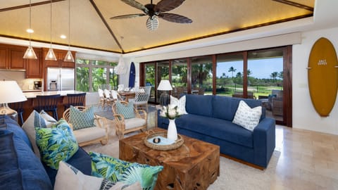 Open concept living area with huge glass doors that lead to backyard pool