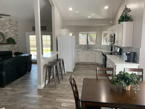 Kitchen into dining room.  Complete with all you need to cook a gourmet meal