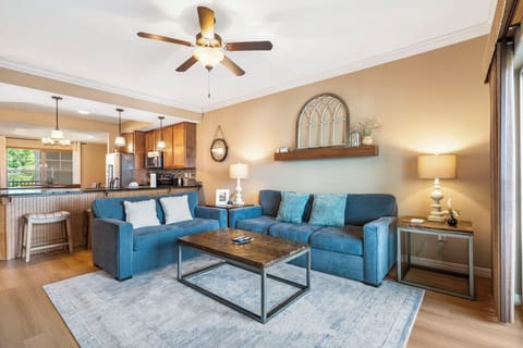 Living space featuring cable TV, a queen sleeper sofa, and access to a deck and sunroom.