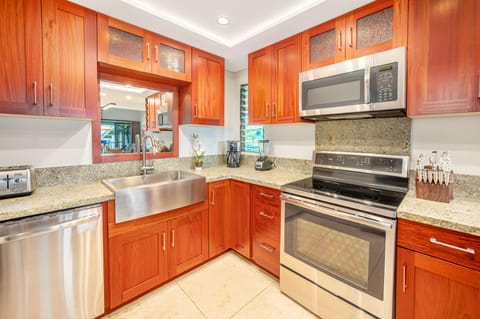 The updated kitchen features sleek stainless steel appliances for all your culinary needs.