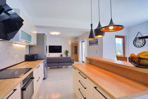 A Fully equipped kitchen with dining area and direct exit to the pool and outdoor dining area
