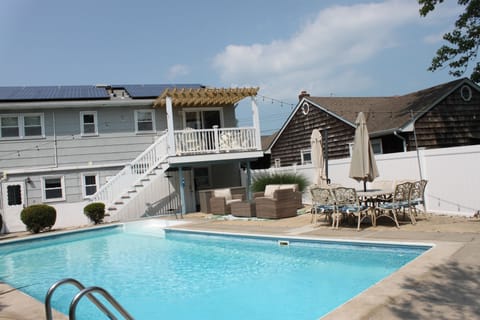 Backyard and pool with seating, dining area, deck & pergola