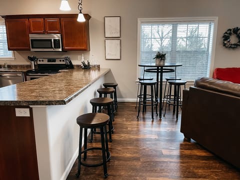 Dining area seats 4 plus 4 bar stools at breakfast bar