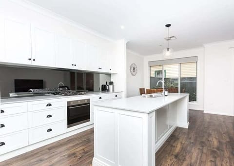 Fully equipped kitchen space with island, stove, and oven.