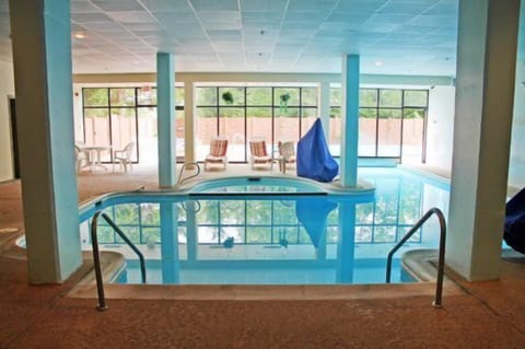 Indoor/outdoor pool area with hottub
