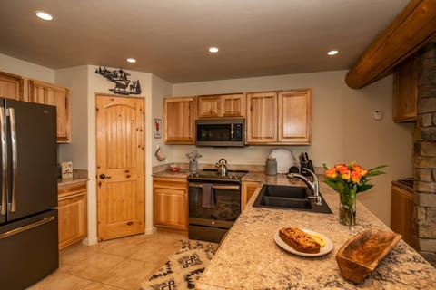 Kitchen has ample counter space and pantry for storage.