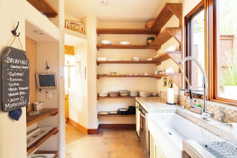 The kitchen includes a gorgeous ceramic farmhouse sink and chef style spray faucet 