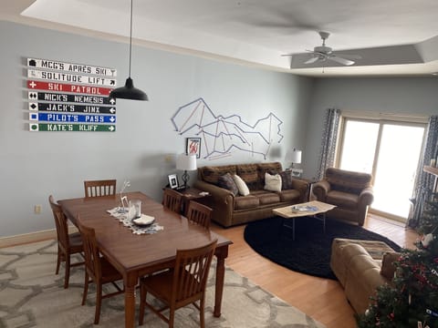 Bright LR/DR area with fireplace and large smart TV