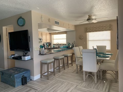 Dining area, table seats six and four barstools too.