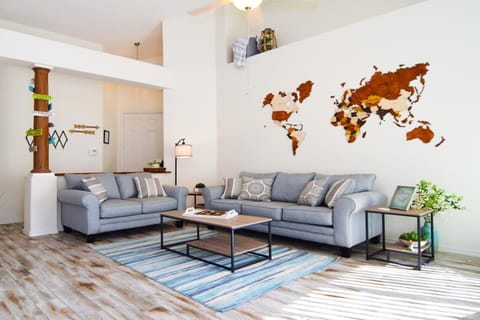 Stylish open-plan living space with sofas, flat screen SMART Roku TV