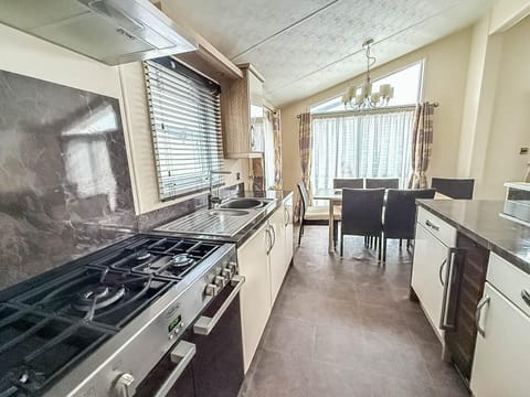 Modern kitchen with sleek appliances and cozy dining area