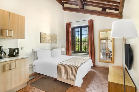 Rest in a sunlit bedroom where modern simplicity meets rustic Italian charm.