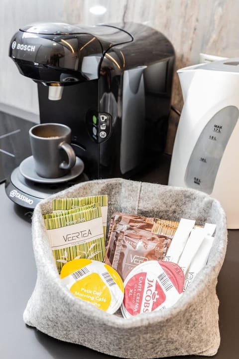 Enjoy a fresh cup of coffee from the coffee machine in the well-appointed kitchenette.