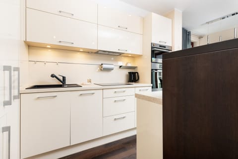 Elegant white kitchen cabinetry with LED lighting.
