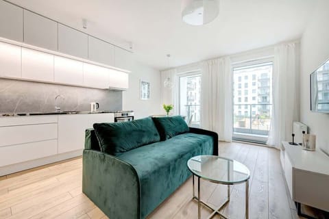 Living room shot featuring the green velvet sofa, with a soft, light-filled ambiance and a coffee table.