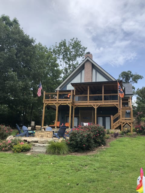 Fire pit, lounge chairs and a bed swing on the lower level deck.