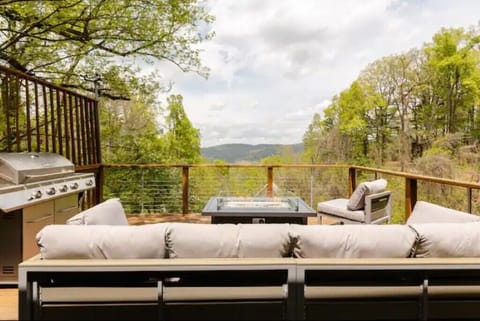 Deck with a fire table, comfortable seating, and a great view!