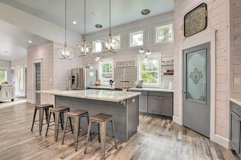10 foot eating bar island in kitchen with glass panel pantry door. 