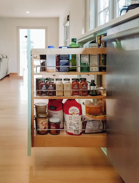 Pull out pantry has spices, flour, condiments and more.
