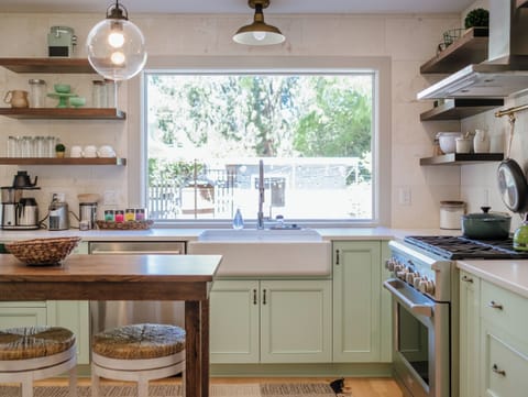 Take in the view of the back yard while preparing a meal in the custom chef's kitchen.